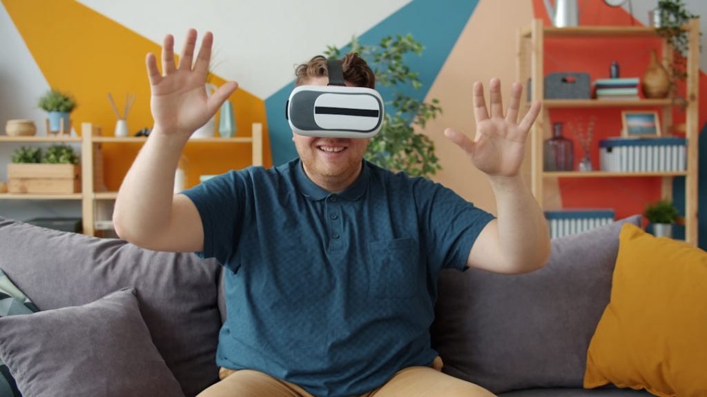 Person wearing vr headset with hands raised