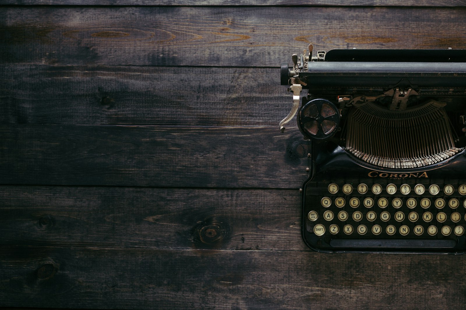 Vintage typewriter on a dark wooden table